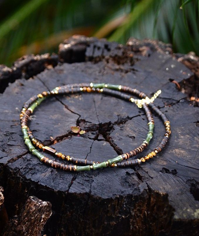 A Worn by Wanderers necklace worn against warm afternoon light