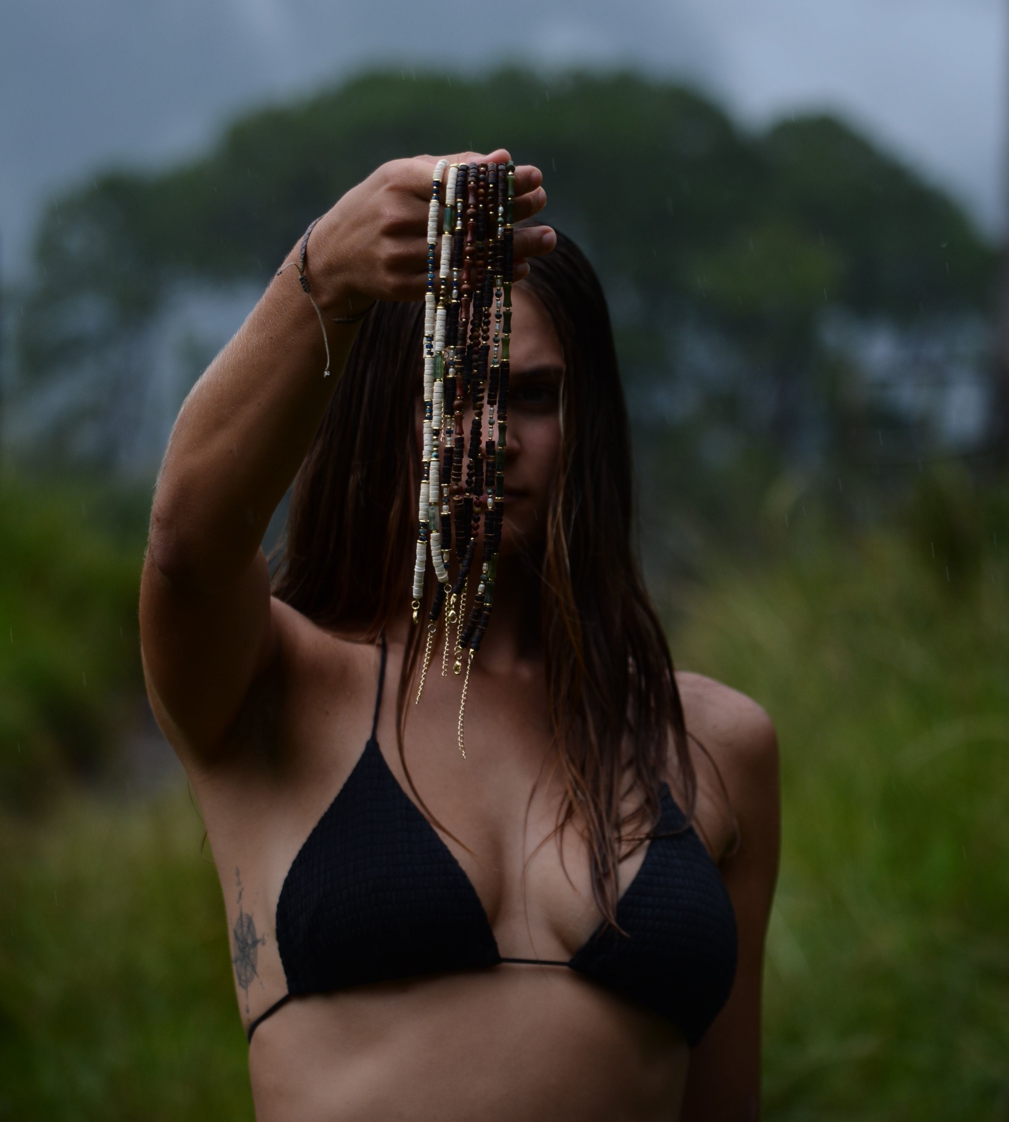 Emma at work, stringing a necklace by hand